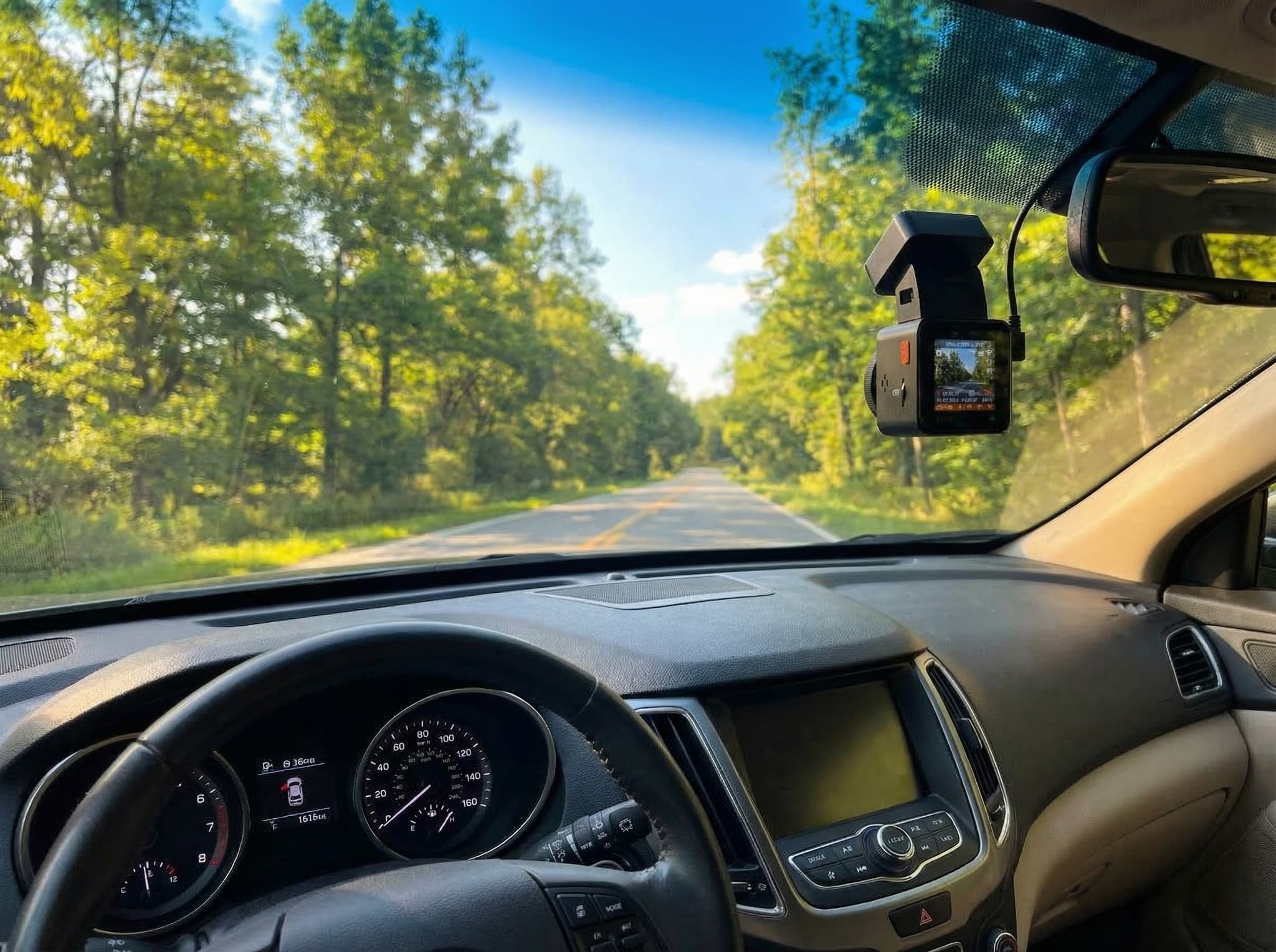 Vantrue E1 Pro 4K compact square dash cam mounted on windshield, shown next to a coin for size comparison